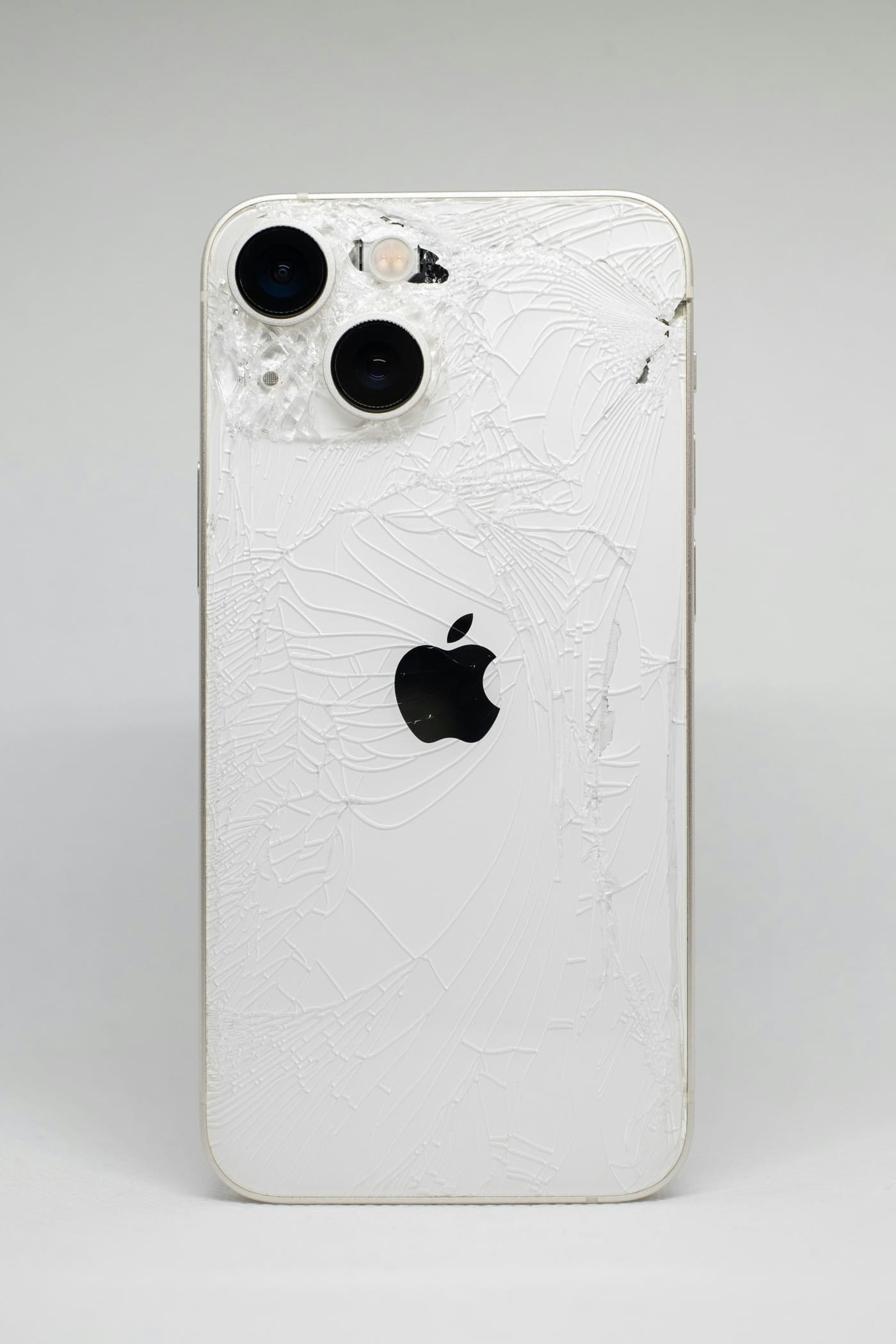 Technician replacing cracked phone back glass