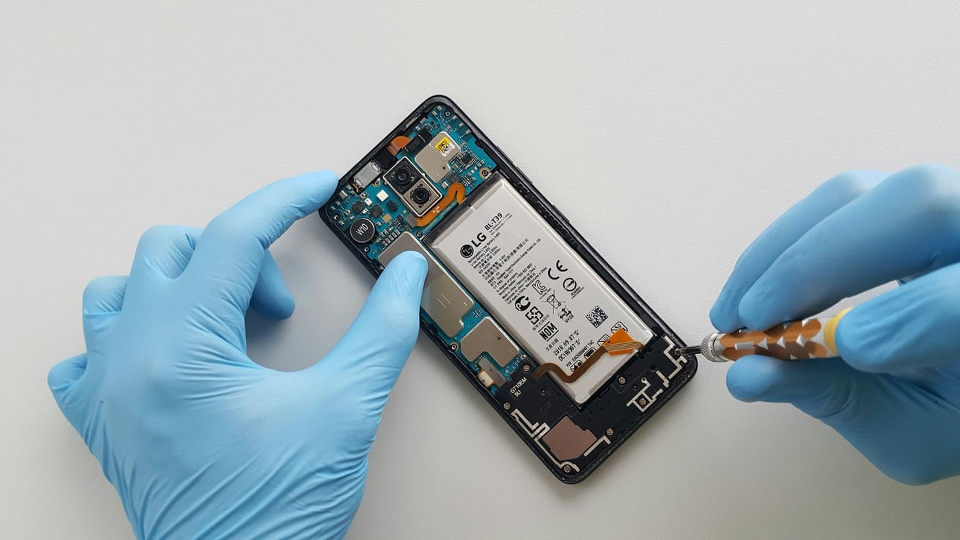 Technician treating a water-damaged phone board